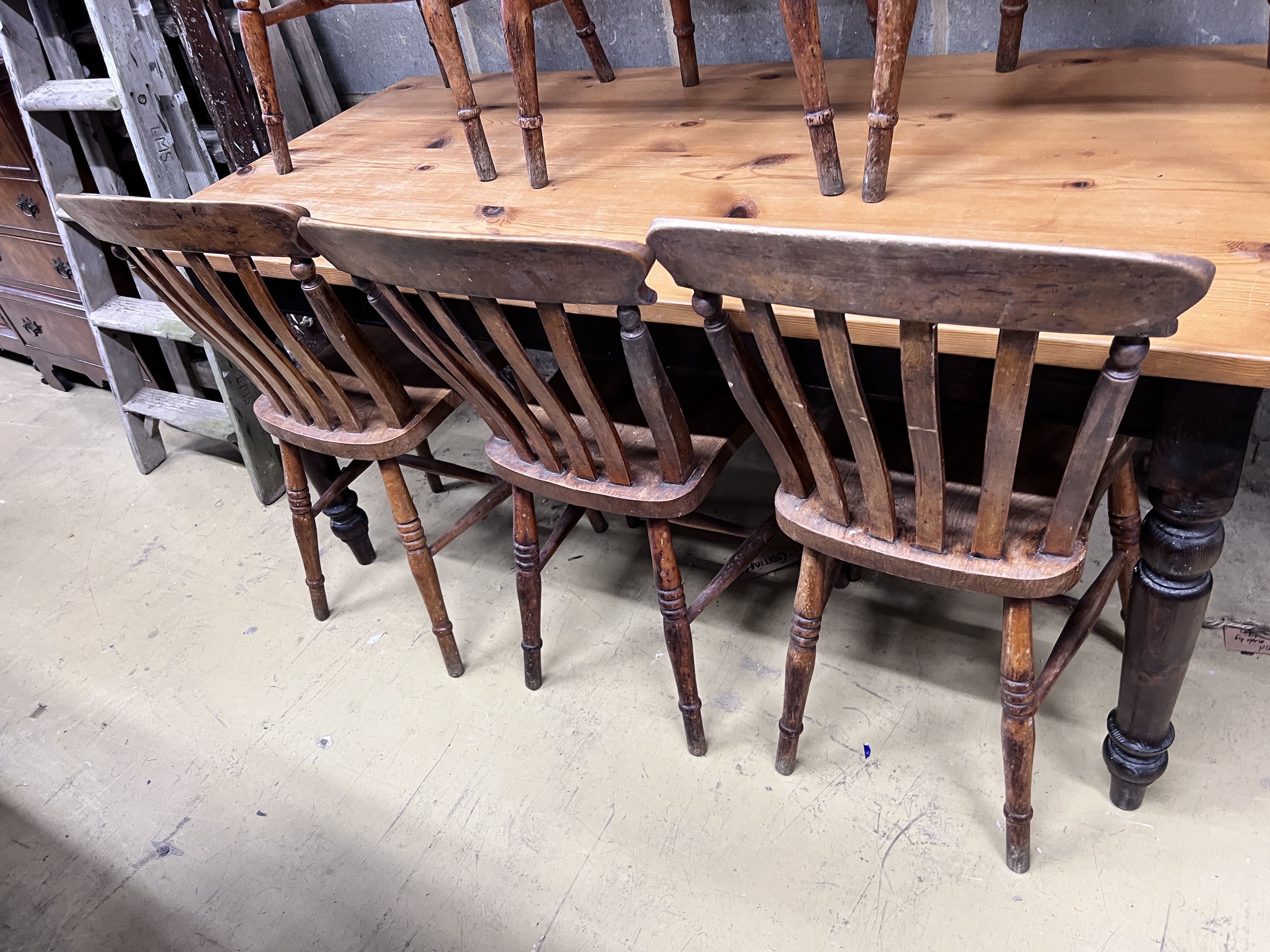 A Victorian style pine kitchen table with ebonised underframe, length 163cm, height 76cm and a set of six early 20th century lathe back kitchen chairs